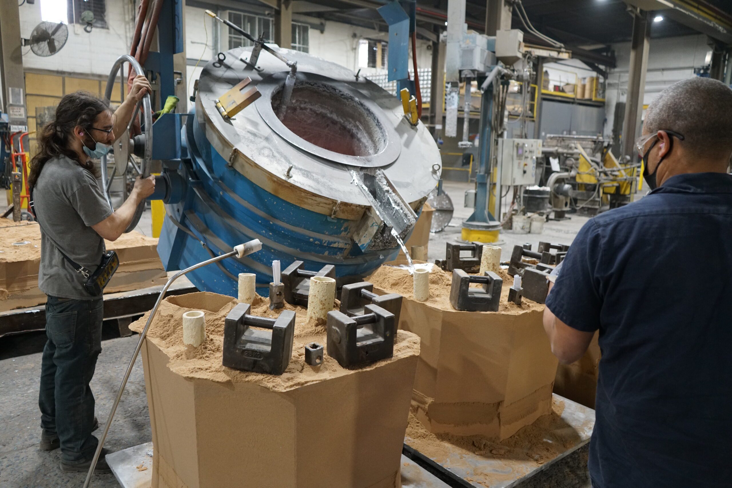 Aluminum being poured into molds.